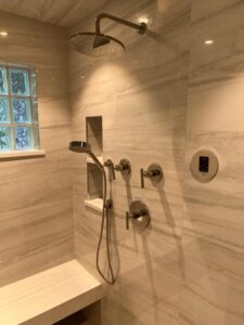 a bathroom with a shower and a bench